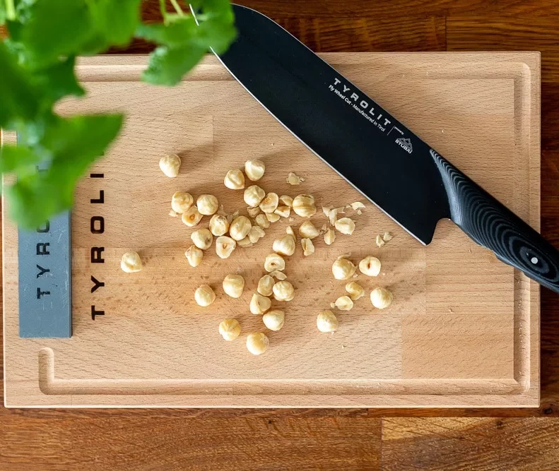 TYROLIT Life Darkline Fly Wheel Cut Nuts on Cutting Board